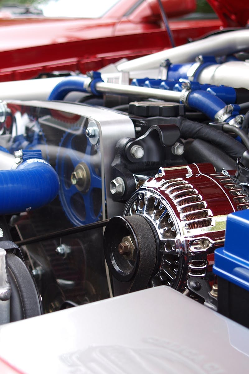 Detailed view of a clean modern car engine with vibrant colored components and sleek design.